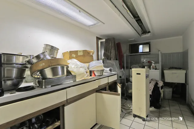 a front view of house with yard and trees in the background