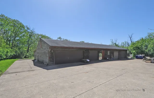 a pathway of a house with potted plants