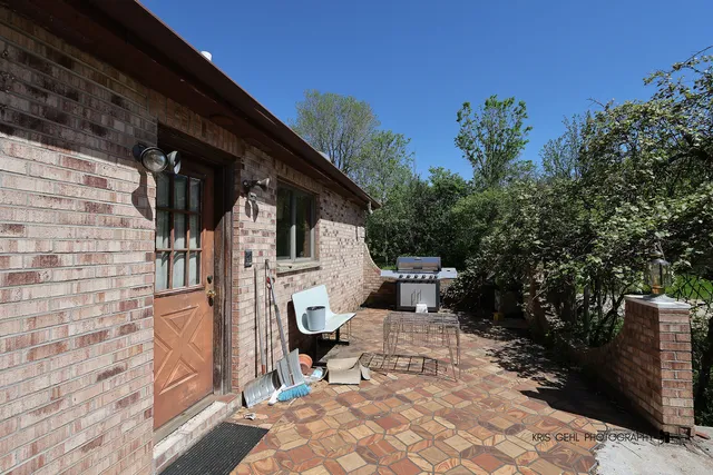 a front view of a house with plants
