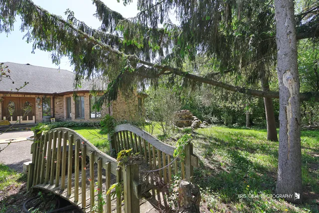 an aerial view of a house with yard