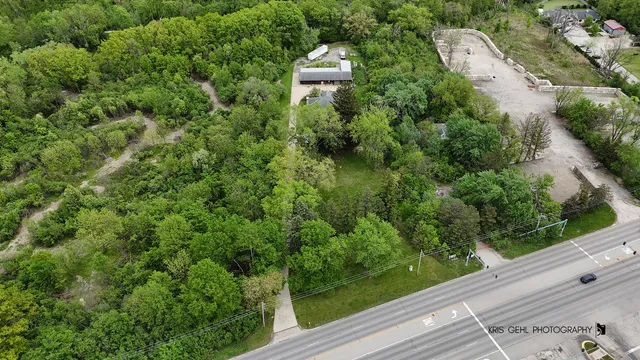 an aerial view of a house with a yard and garden