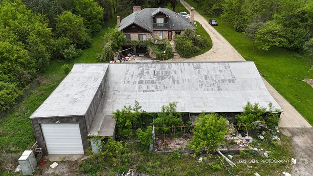 an aerial view of a house with a yard