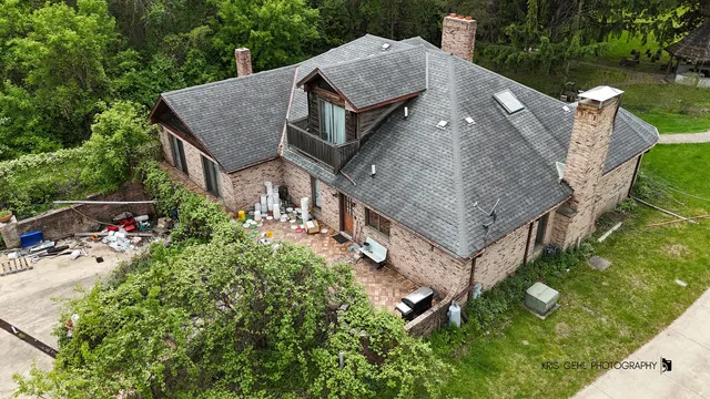 an aerial view of a house with a yard