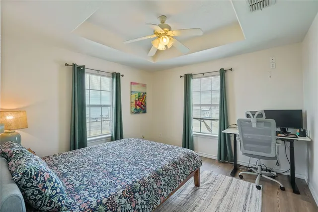 a bedroom with a bed and a chandelier