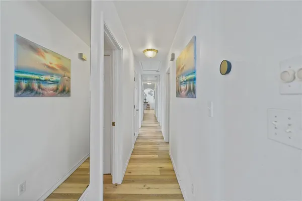 a view of a hallway with wooden floor