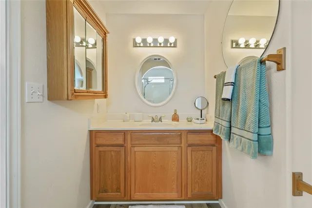 a bathroom with a toilet a sink and a mirror