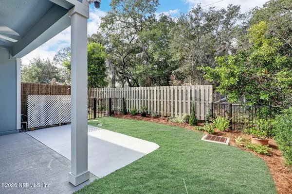 a view of a backyard with a garden and deck