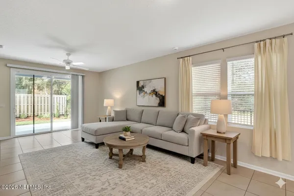 a living room with furniture and a large window