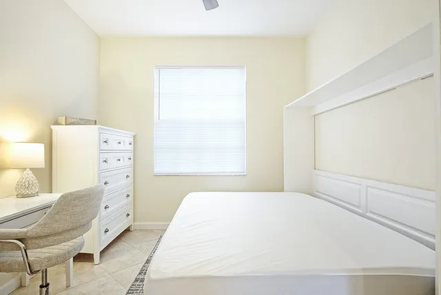 a large white bed in a white room