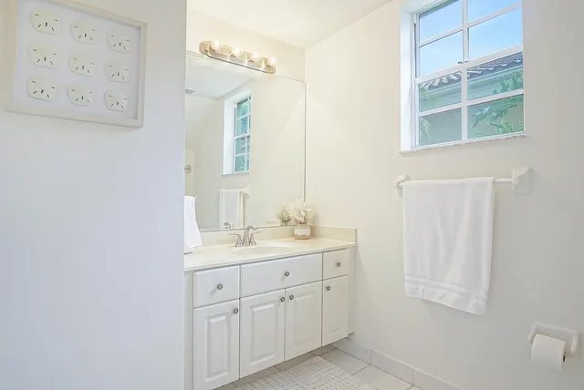 a bathroom with a double vanity sink and a mirror