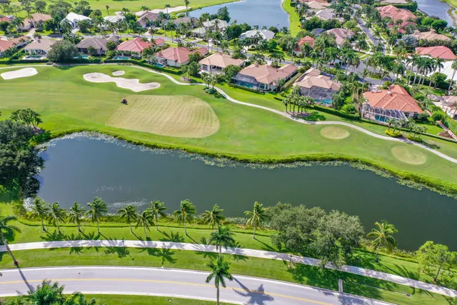 an aerial view of a house with a garden and lake view
