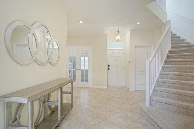 a view of an entryway with wooden floor and mirror