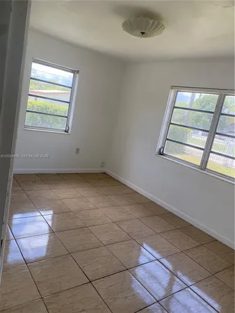 a view of a livingroom with an empty space and a window