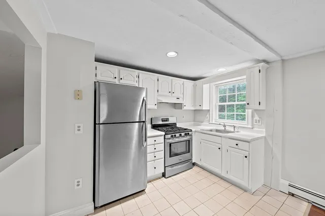a kitchen with stainless steel appliances a stove sink and refrigerator