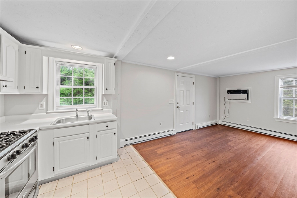238 Neponset Street, Unit 2 Canton, MA 02021 - Photo 3 of 22 a kitchen with a sink wooden floor and window