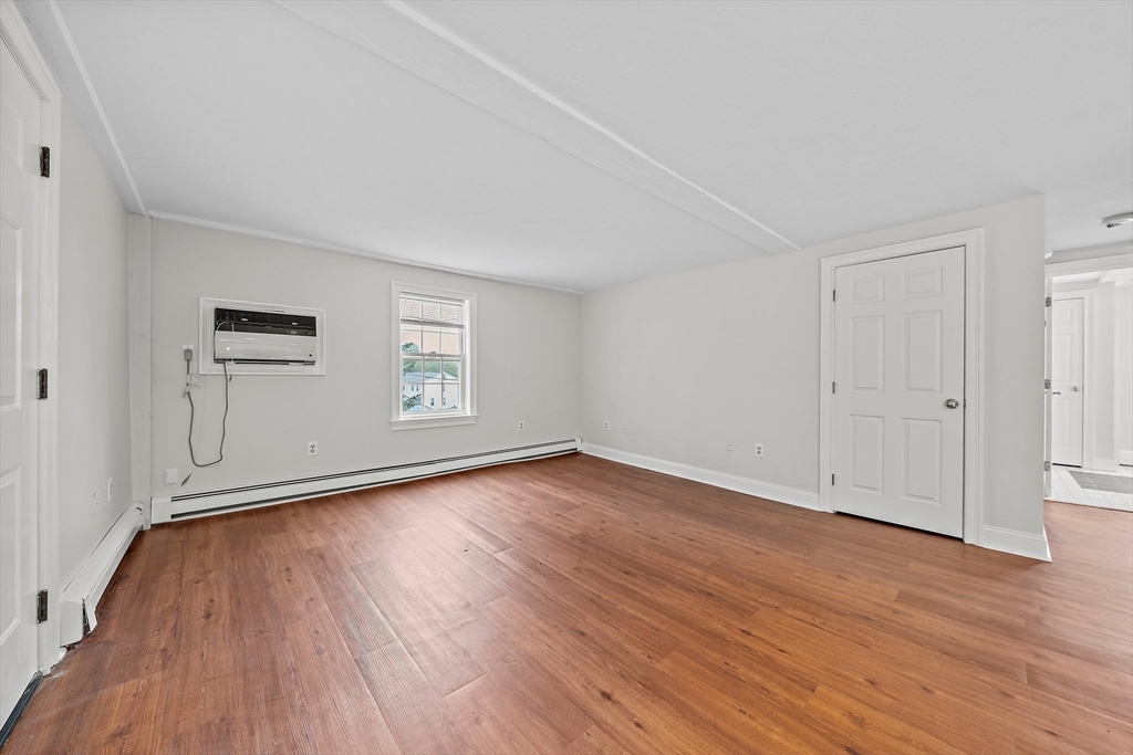 238 Neponset Street, Unit 2 Canton, MA 02021 - Photo 5 of 22 a view of empty room with wooden floor and window