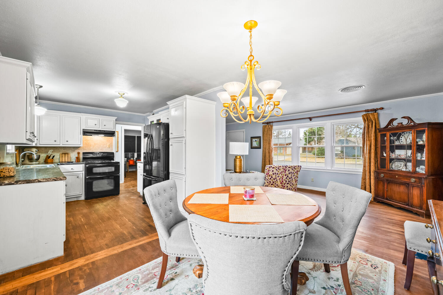 3104 26th Street Lubbock, TX 79410 - Photo 6 of 19 a dining room with furniture a chandelier and wooden floor