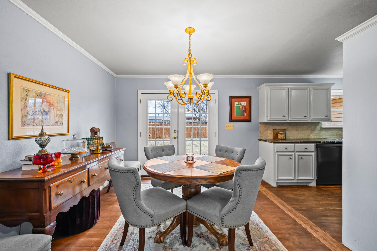 3104 26th Street Lubbock, TX 79410 - Photo 7 of 19 a view of a dining room with furniture wooden floor and a chandelier