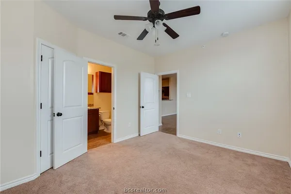 a view of empty room with ceiling fan