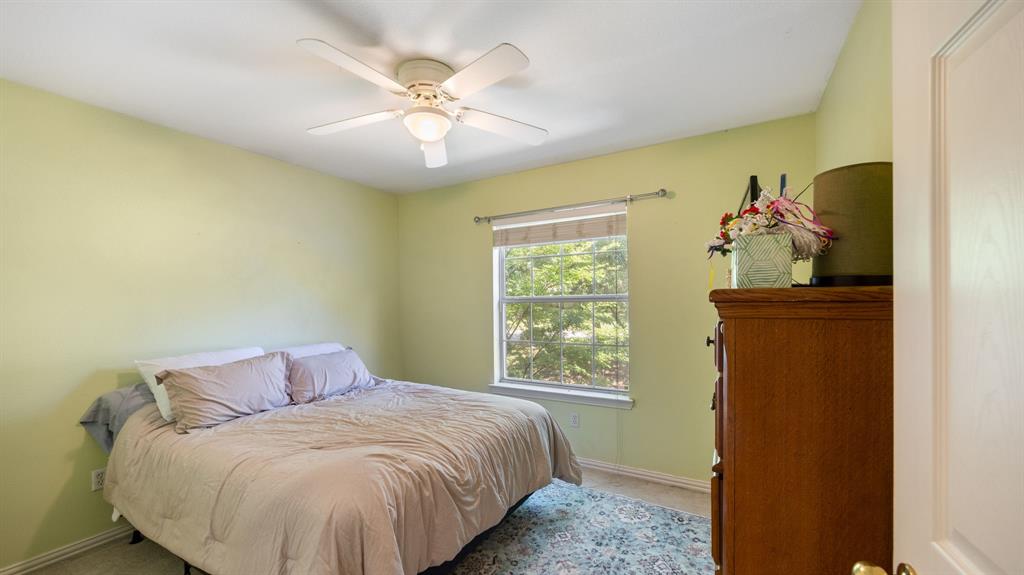1508 Valley Creek Road Denton, TX 76205 - Photo 32 of 33 a bedroom with a bed and a window