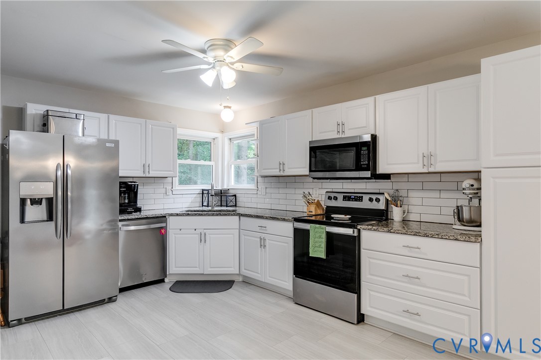 1030 Rock Spring Road Bumpass, VA 23024 - Photo 14 of 34 a kitchen with a stove microwave and refrigerator