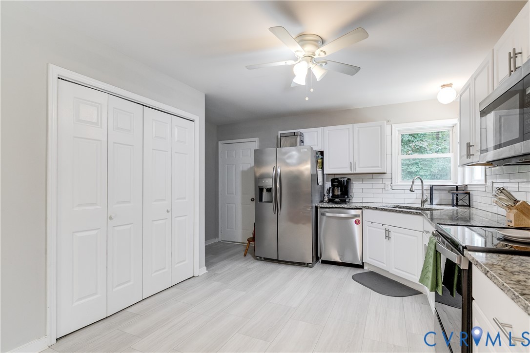 1030 Rock Spring Road Bumpass, VA 23024 - Photo 16 of 34 a kitchen with stainless steel appliances granite countertop a stove a sink dishwasher a refrigerator and a refrigerator