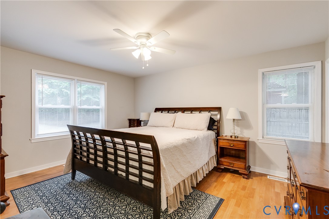 1030 Rock Spring Road Bumpass, VA 23024 - Photo 17 of 34 a bedroom with a bed and wooden floor
