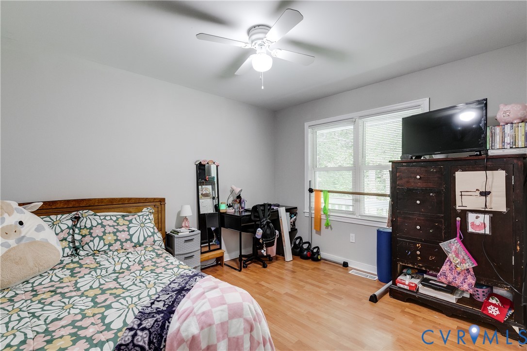 1030 Rock Spring Road Bumpass, VA 23024 - Photo 21 of 34 a bedroom with a bed and a flat screen tv