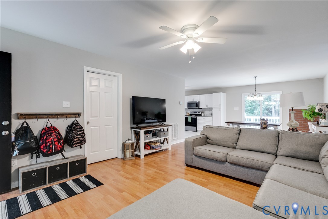 1030 Rock Spring Road Bumpass, VA 23024 - Photo 5 of 34 a living room with furniture flat screen tv and a fireplace