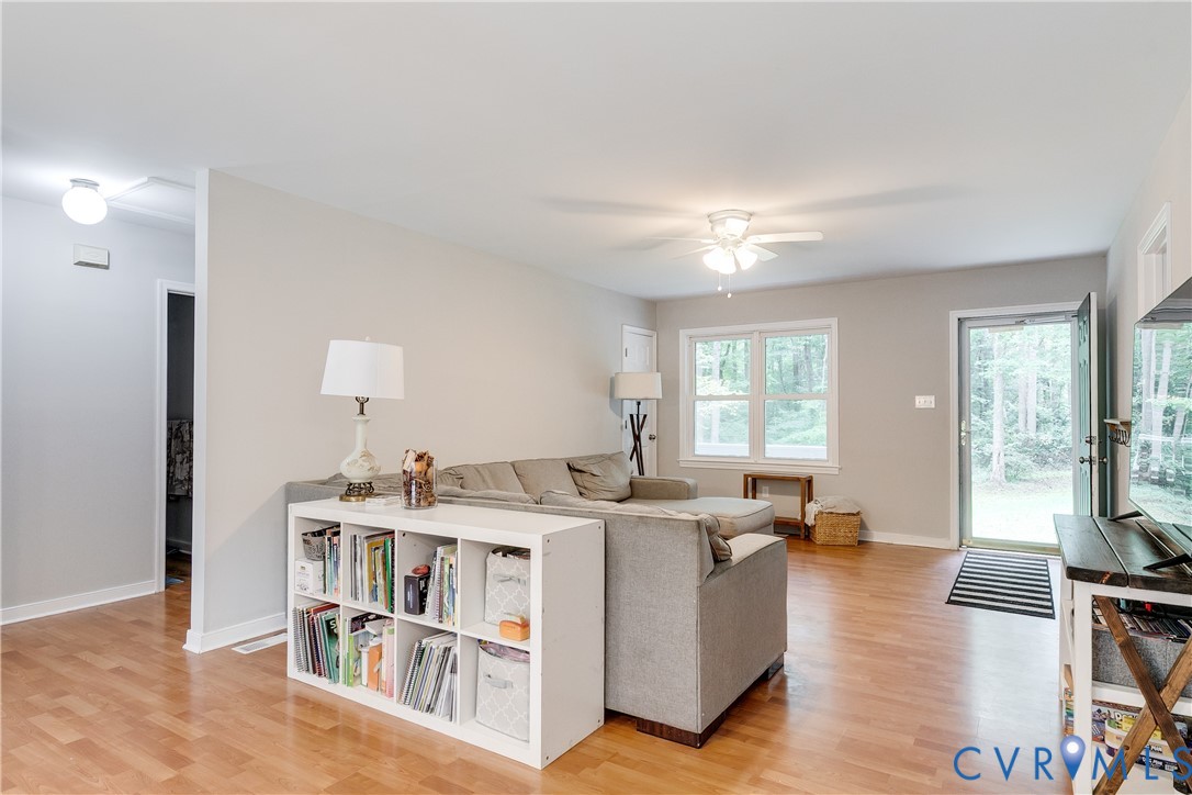 1030 Rock Spring Road Bumpass, VA 23024 - Photo 6 of 34 a living room with furniture a window and a book shelf