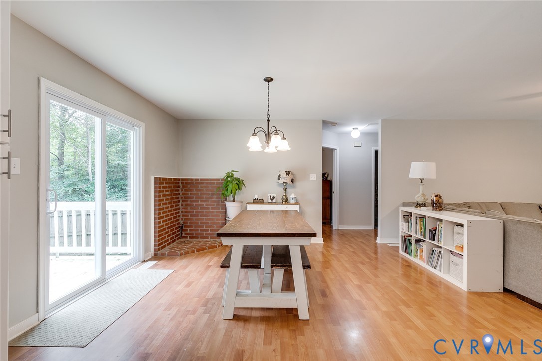 1030 Rock Spring Road Bumpass, VA 23024 - Photo 8 of 34 a view of a dining room with furniture window and wooden floor