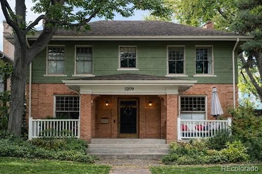 2209 Ash Street Denver, CO 80207 - Photo 2 of 37 a front view of a house with garden