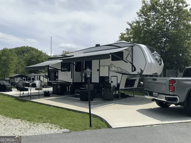 a view of a chairs and tables in the back yard of the house