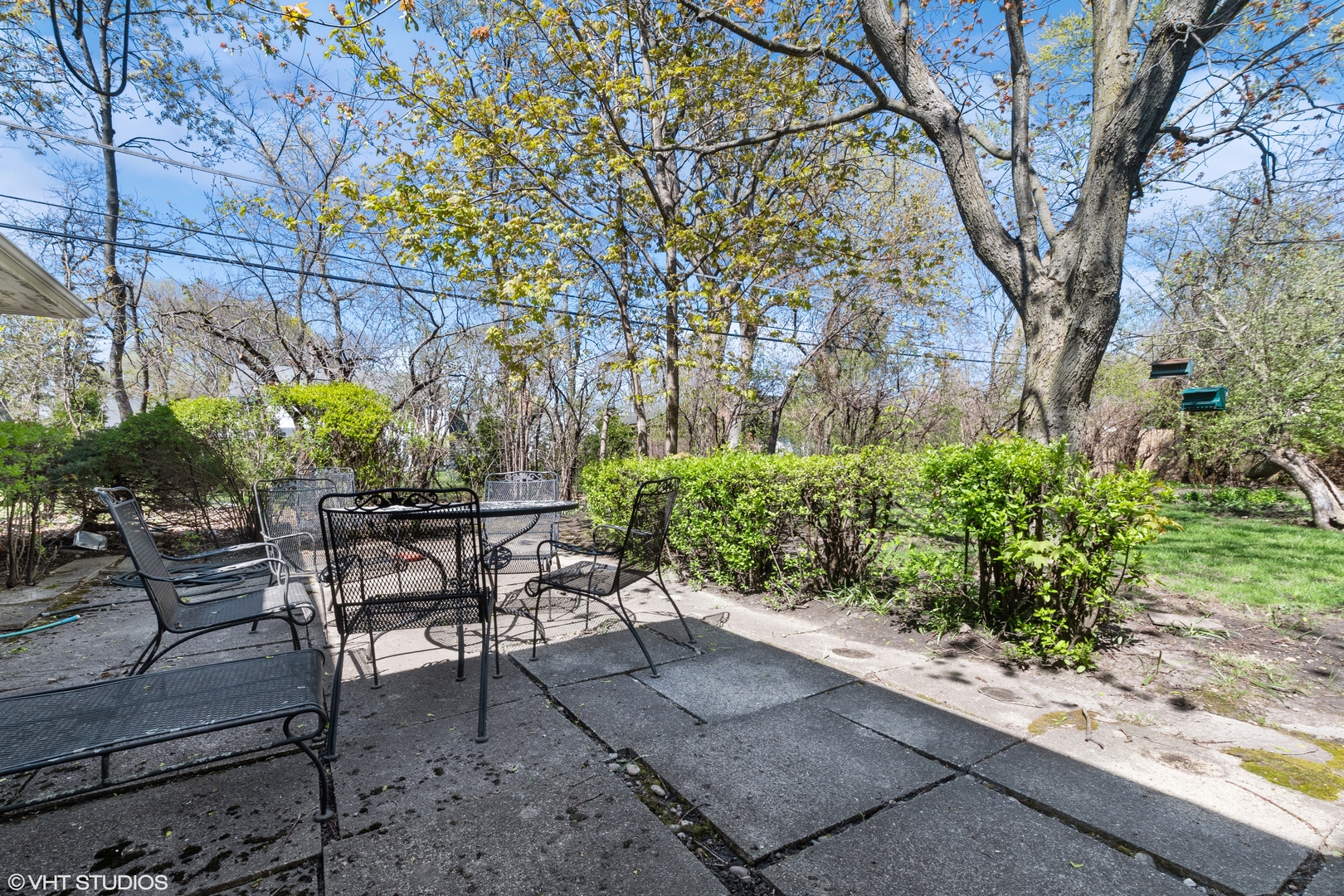 593 Greenvale Road Lake Forest, IL 60045 - Photo 4 of 5 a patio with table and chairs and potted plants