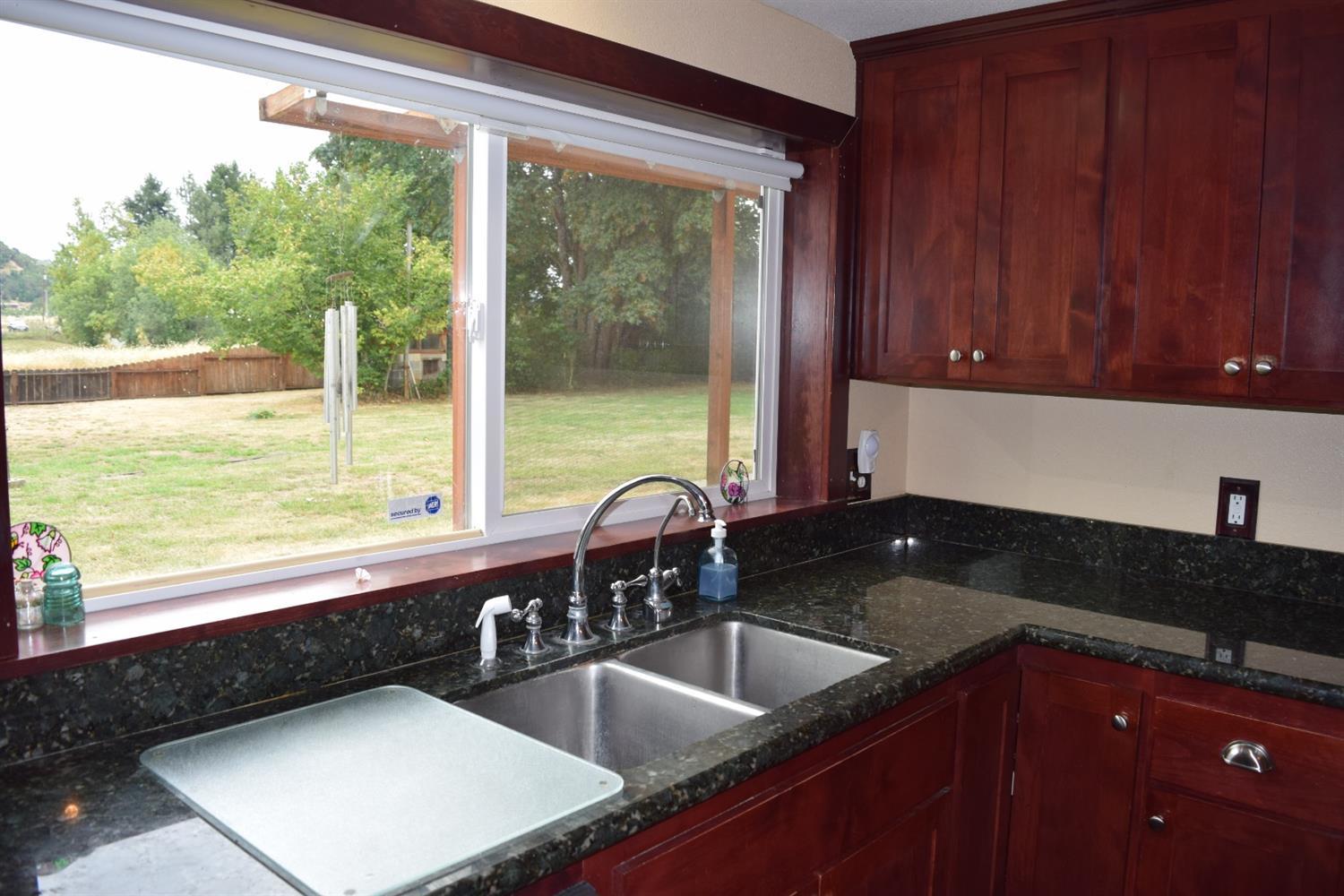 847 Big Bend Road Roseburg, OR 97471 - Photo 11 of 25 a kitchen with granite countertop a sink and a wooden floor