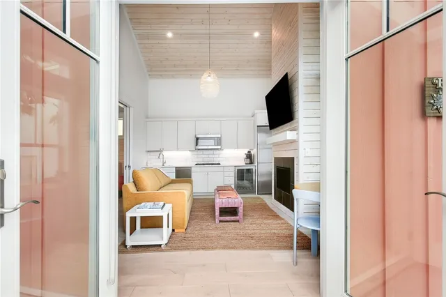 a living room with furniture a flat screen tv and a fireplace