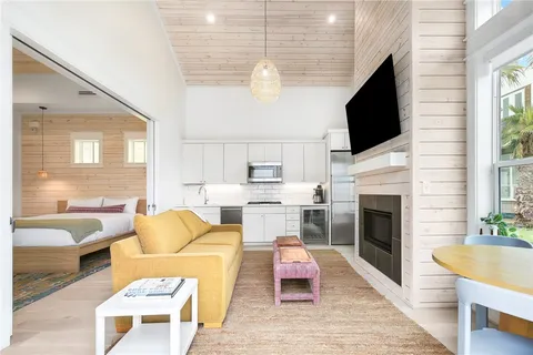 a living room with furniture fireplace and a flat screen tv