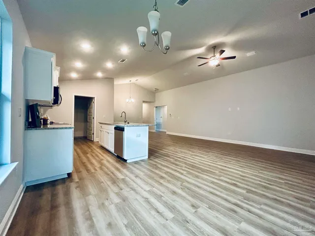a kitchen with wooden floors and a sink