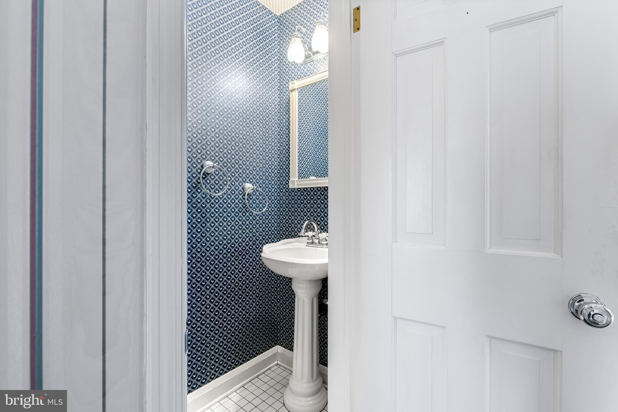 1607 Ruxton Road Towson, MD 21204 - Photo 16 of 46 a bathroom with a sink and a mirror