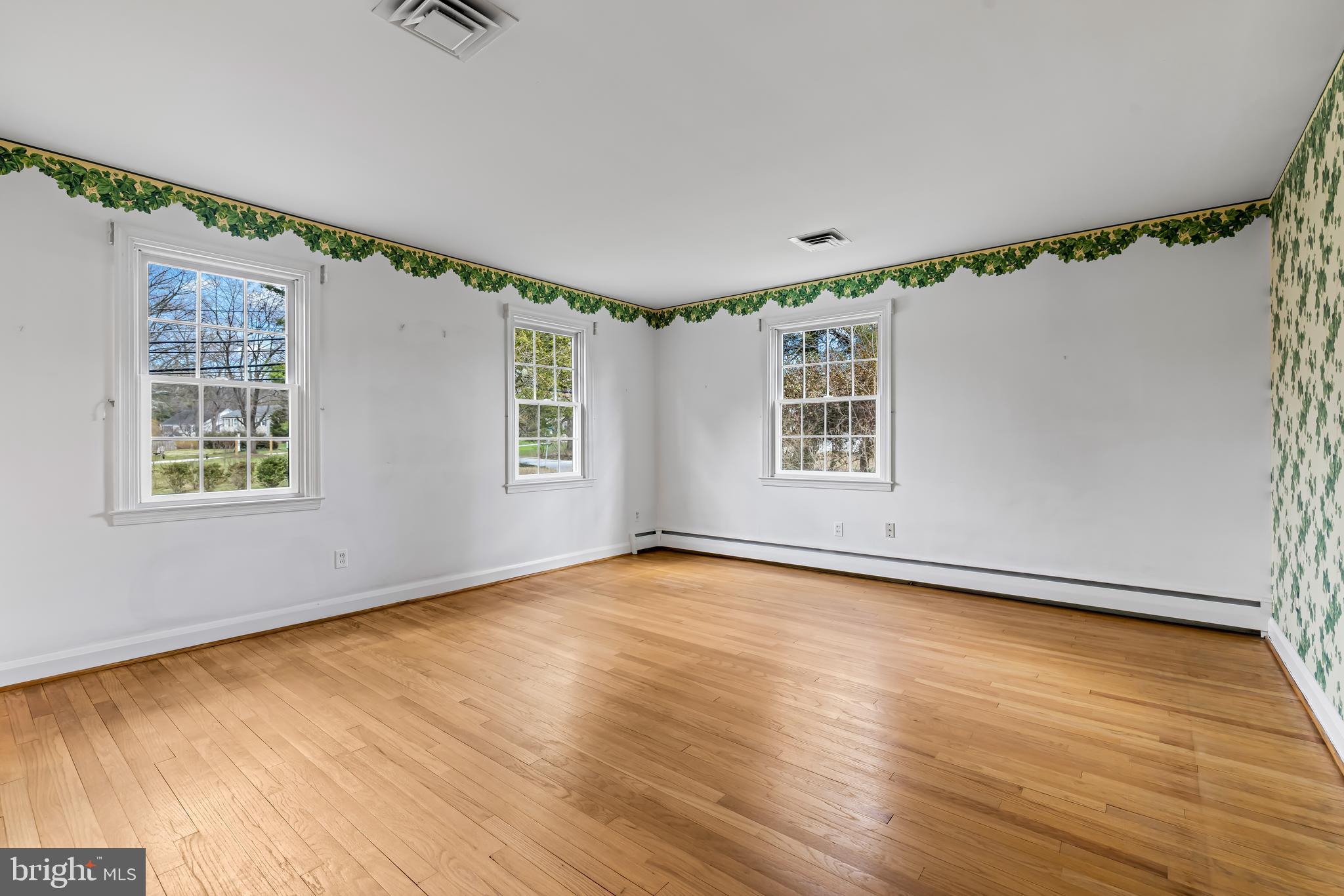 1607 Ruxton Road Towson, MD 21204 - Photo 29 of 46 a view of an empty room with a window and wooden floor