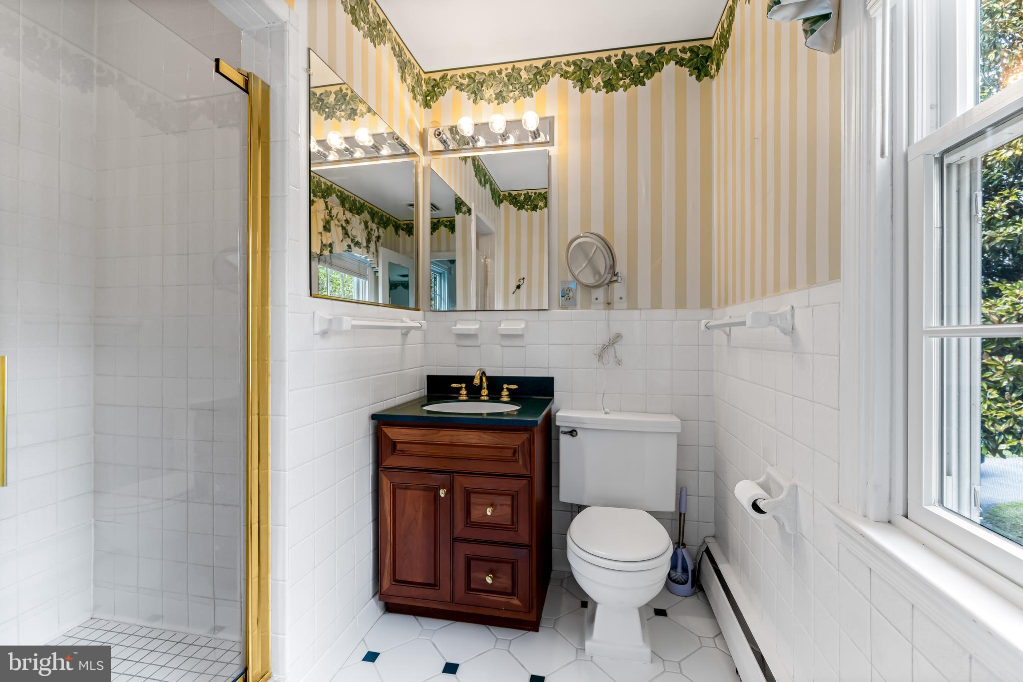 1607 Ruxton Road Towson, MD 21204 - Photo 32 of 46 a bathroom with a granite countertop sink toilet and shower