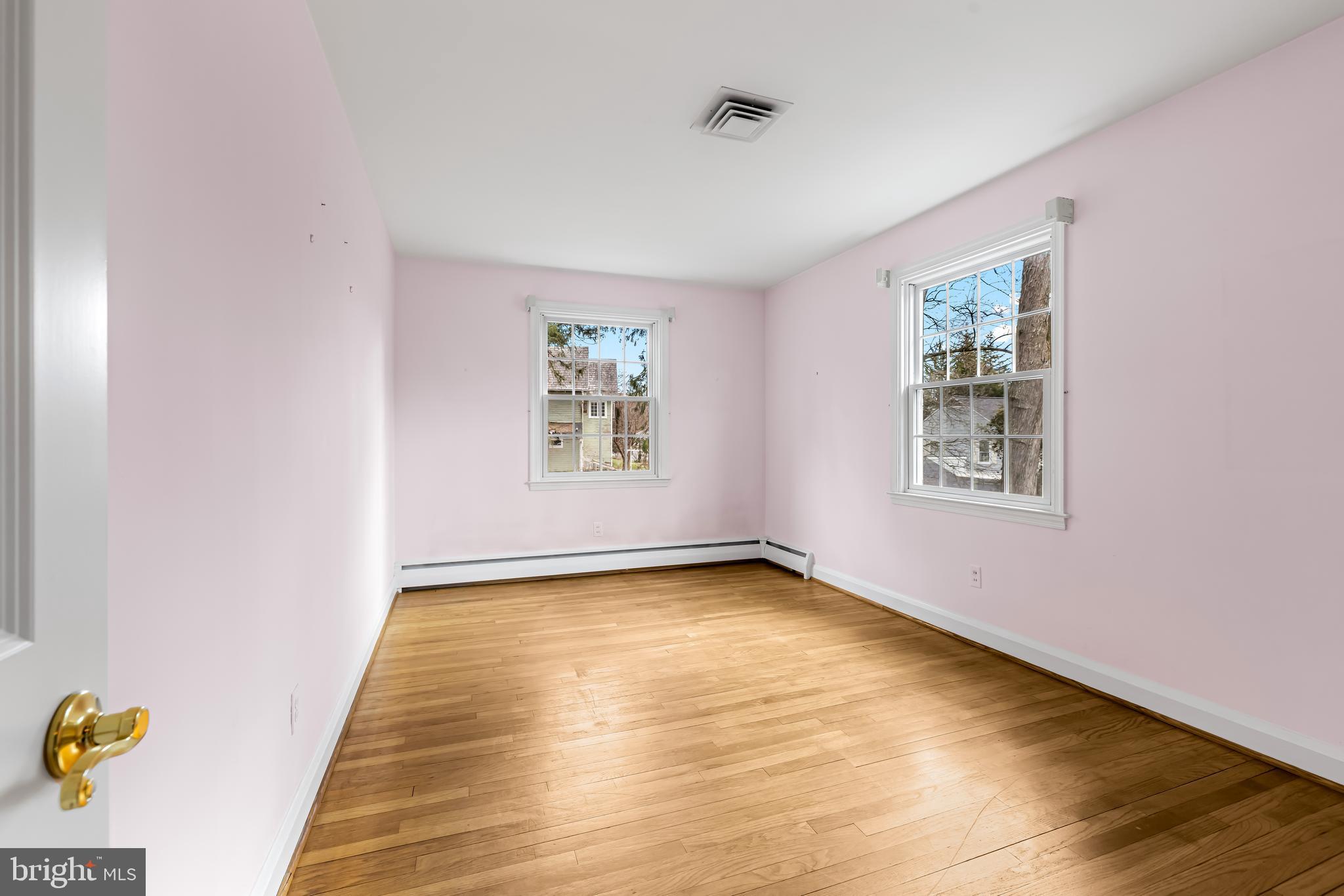 1607 Ruxton Road Towson, MD 21204 - Photo 35 of 46 a view of an empty room with a window and wooden floor