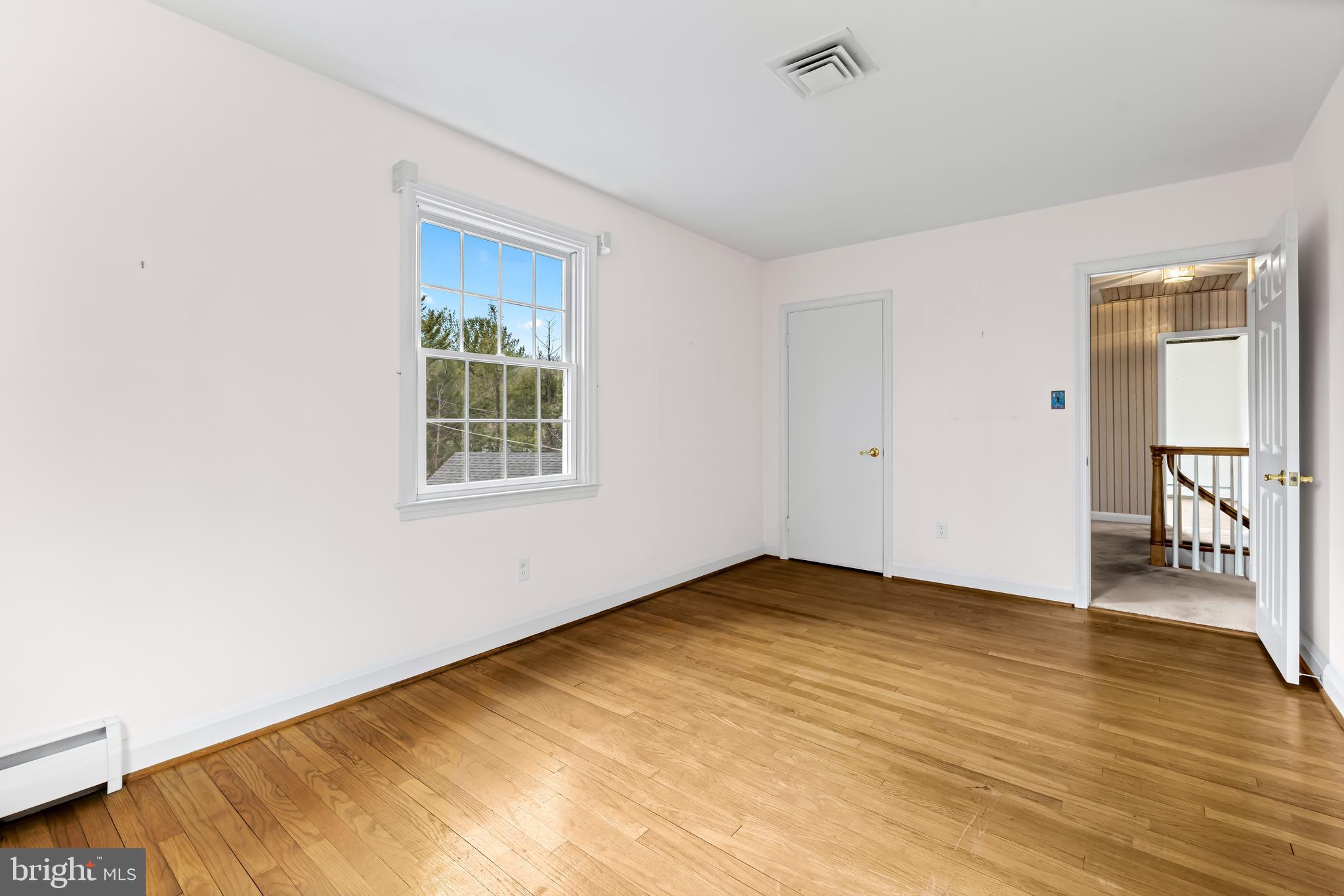 1607 Ruxton Road Towson, MD 21204 - Photo 36 of 46 a view of an empty room with wooden floor and a window