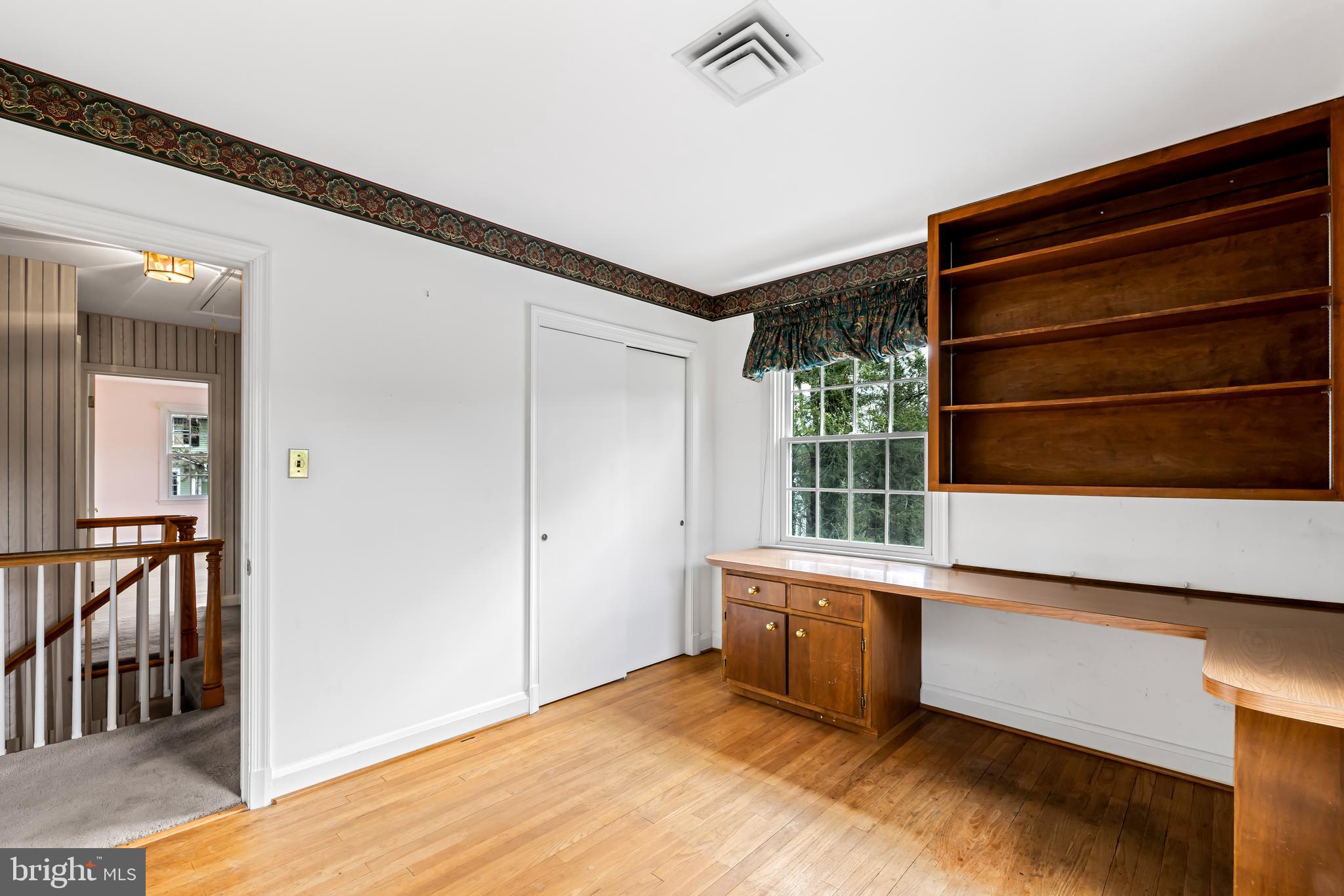 1607 Ruxton Road Towson, MD 21204 - Photo 39 of 46 a view of an empty room with wooden floor and a window