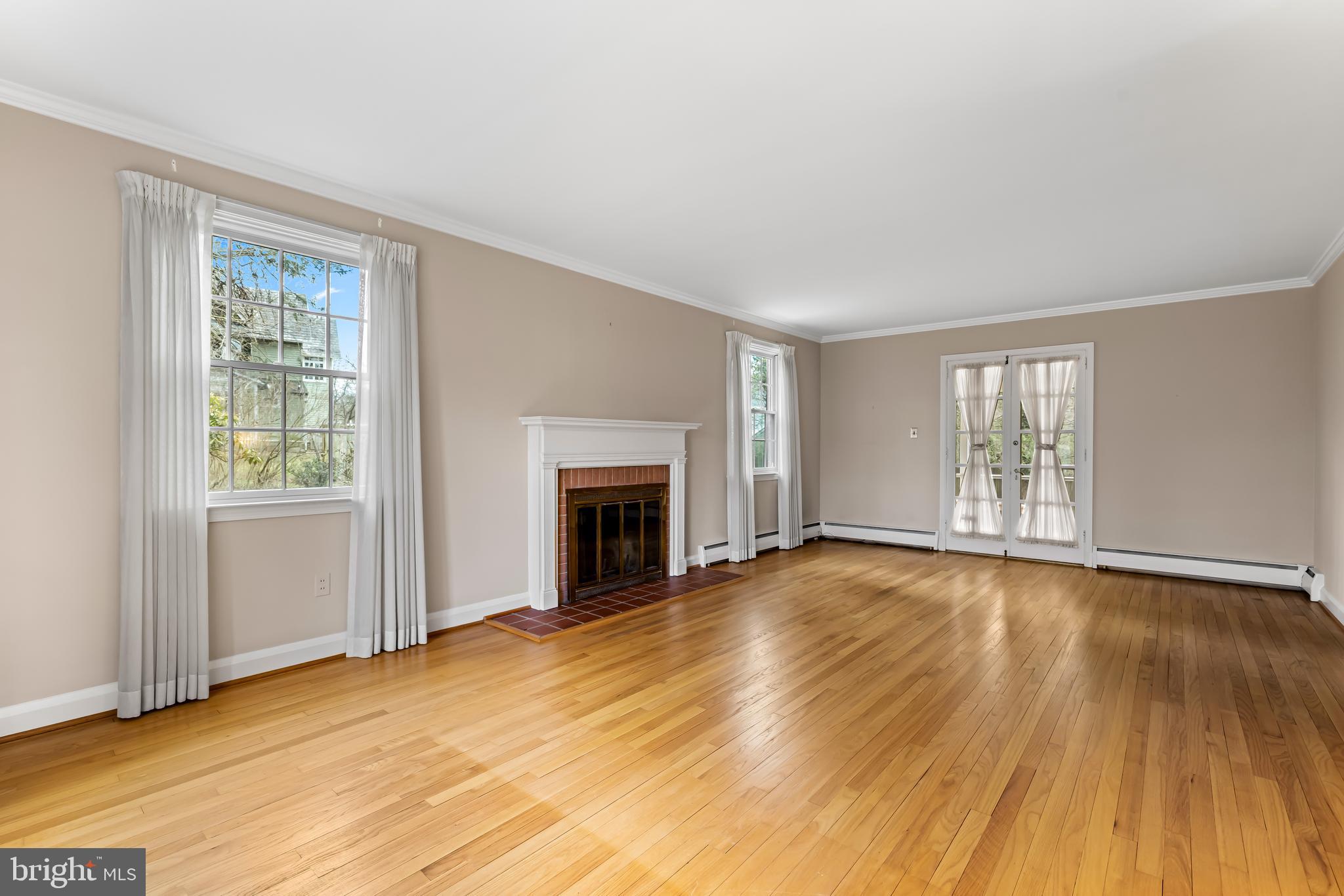1607 Ruxton Road Towson, MD 21204 - Photo 7 of 46 a view of empty room with wooden floor and fireplace