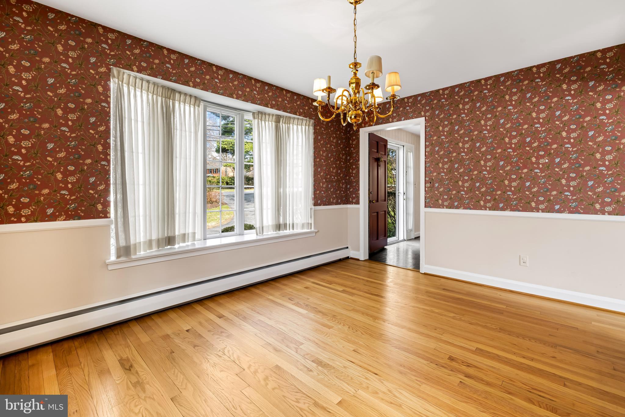1607 Ruxton Road Towson, MD 21204 - Photo 10 of 46 a view of an empty room with a window and wooden floor