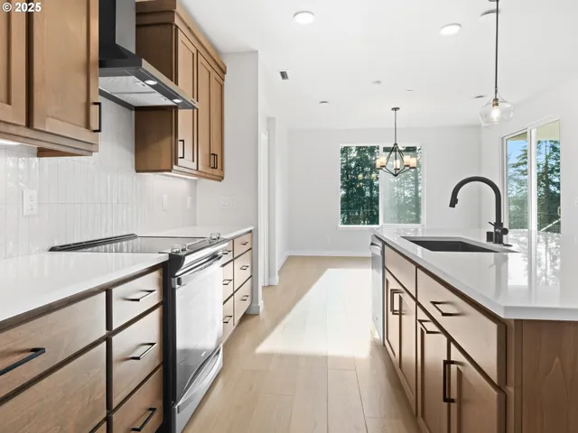a kitchen with a sink appliances and cabinets