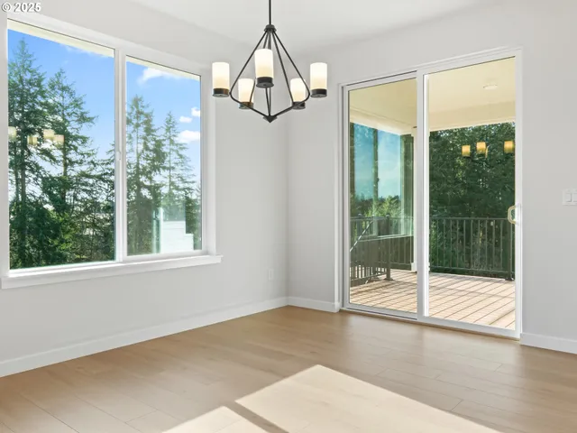 a view of a room with wooden floor chandeliers and a chandelier