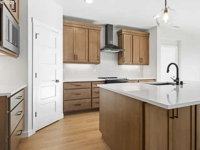 a kitchen with white cabinets and sink