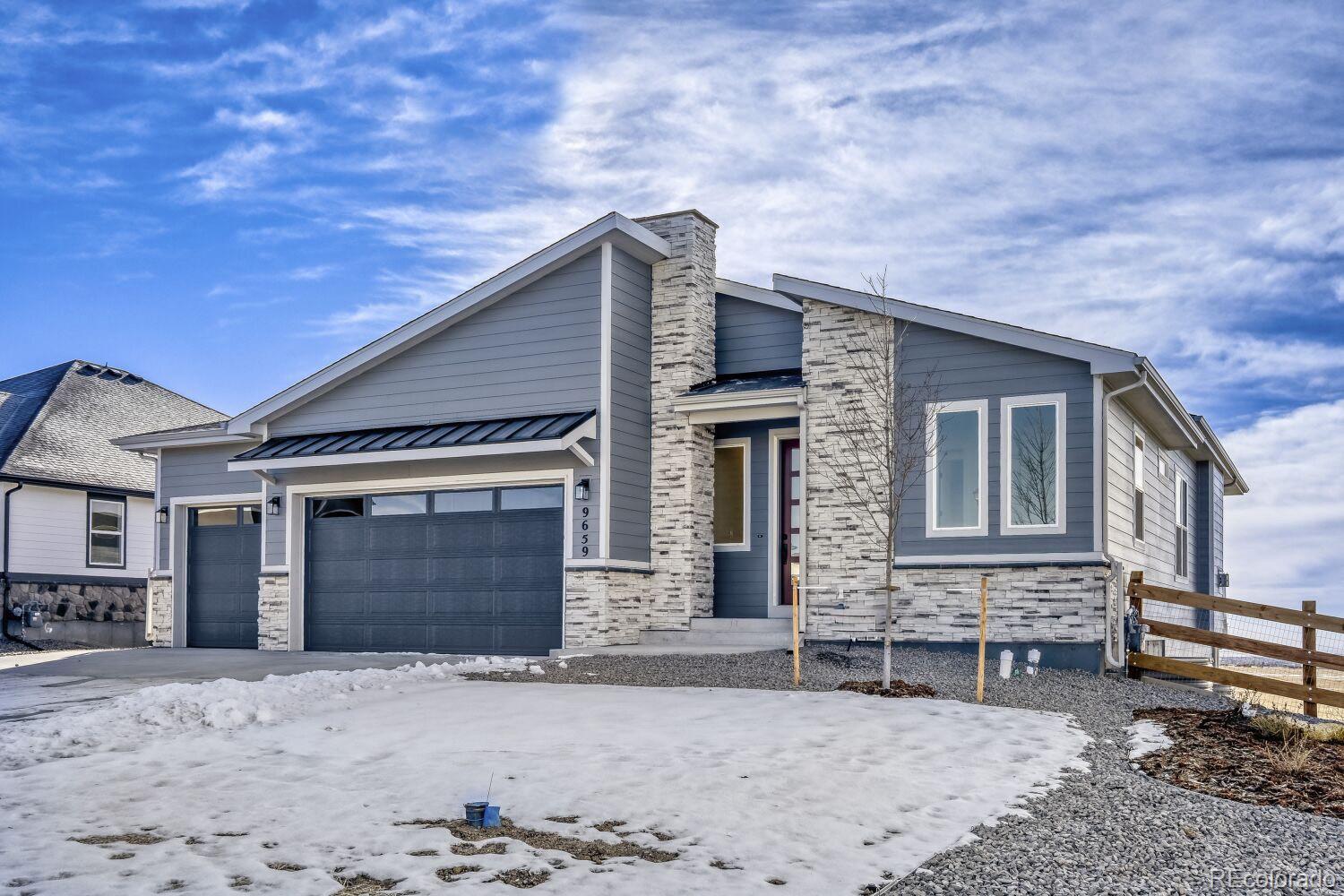 9659 Owl Perch Loop Colorado Springs, CO 80908 - Photo 2 of 28 a front view of a house with a yard and garage